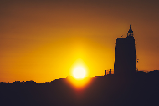 Sunset over Carbonera Lighthouse located on Punta Mala, La Alcaidesa, Spain. Lantern overlooks the Strait of Gibraltar.
