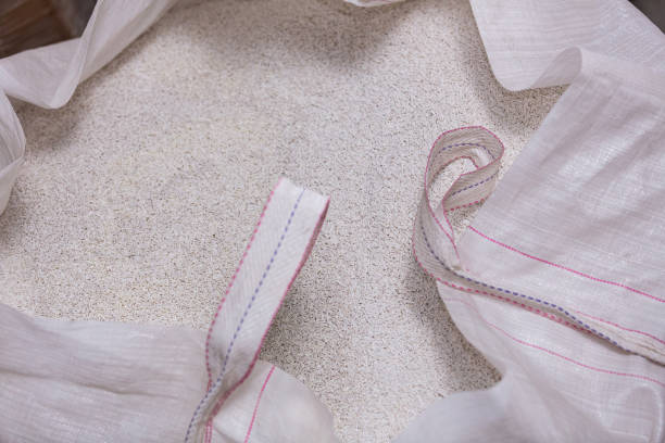 Close up of white plastic polymer granules. Polymer plastic. Composite polymer. PVC resin compounds. Tinted plastic granules for the injection molding process - Textil industry - Buenos Aires - Argentina