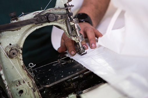 Worker sewing polypropylene bags with a sewing machine - Textile Industry - Buenos Aires - Argentina
