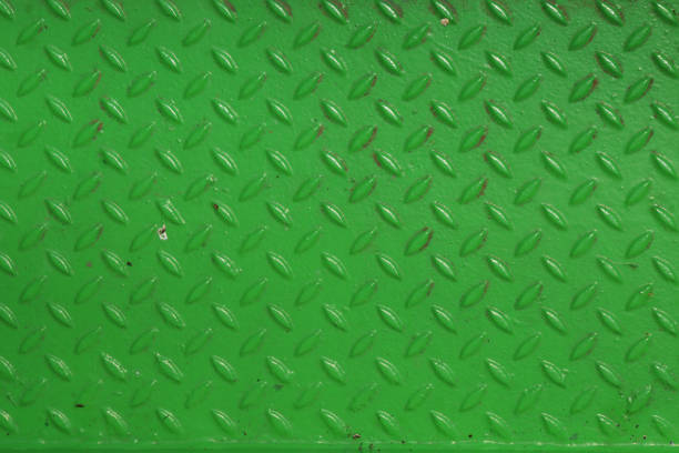 Grunge steel industrial boat floor plate painted vivid green anti-rust paint. Rhombus shapes pattern. Robust ferry ship floor metal pattern. Modern design concept. Factory style. Abstract background. Grunge steel industrial boat floor plate painted vivid green anti-rust paint. Rhombus shapes pattern. Robust ferry ship floor metal pattern. Modern design concept. Factory style. Abstract background. rustproof stock pictures, royalty-free photos & images