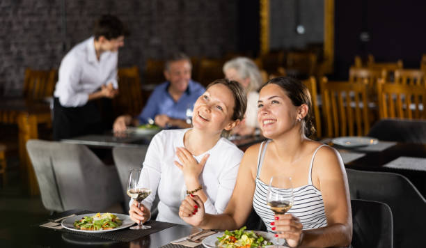 istock Two young women meeting over dinner in restaurant 1496496017