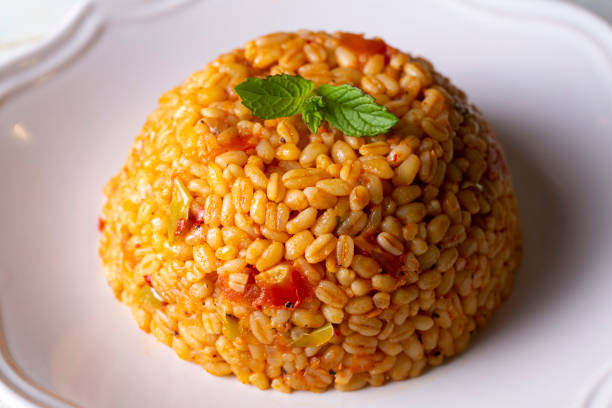 istock Traditional turkish bulgur pilaf with tomato sause in plate (Turkish name; meyhane pilavi) 1496499432