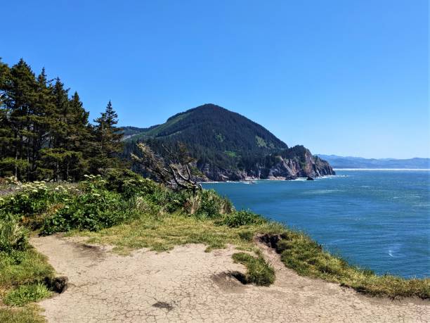 istock Mountain by the ocean with trail in foreground 1496504354