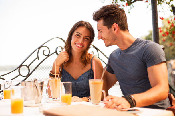 istock Young couple enjoying iced coffee while sitting at the table in a restaurant 1496506706