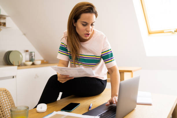 istock Happy young woman enjoying working online 1496507414