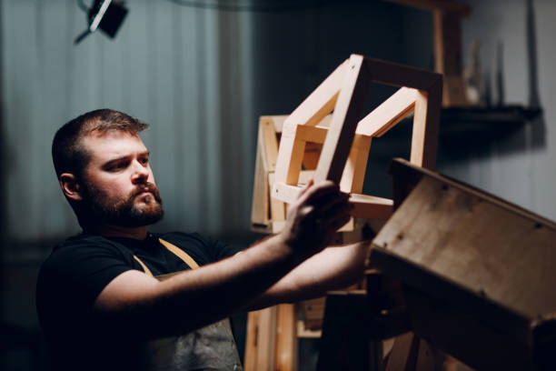 istock Artisan craftsman carpenter sculptor frame wooden create carcass framework. 1496509970