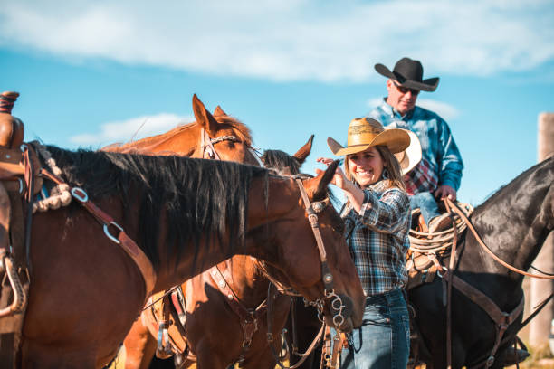 istock Weekend Activities, Cowboys Petting Horses 1496510036