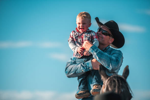 istock Happy Blond Little Boy Being Held by Father 1496510062