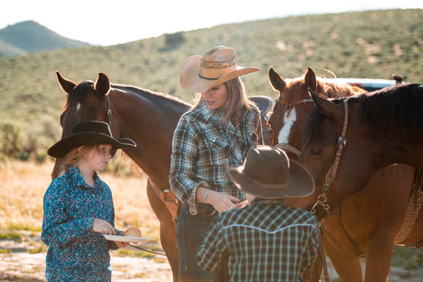 istock Good Looking Mother and Young Kids Using Cowboy Hats 1496510068