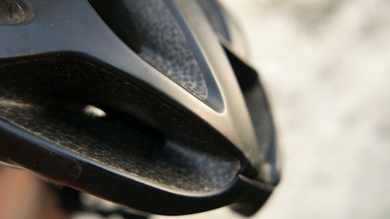 A bike helmet, side view, close-up angle. Safety Item. Cycling day. Bike moments. Bicycle context. Cycling clothing. Safety tool. Bike helmet, close-up shot. Bikers. Sports helmet.