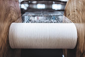 Close up macro detail of Yarn thread lines running in the weaving loom machine. Yarn thread lines background. Yarn thread lines texture. Textured fabric background