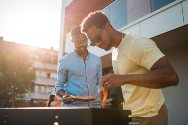 istock Two Husbands Grilling Food Outdoors 1496511618
