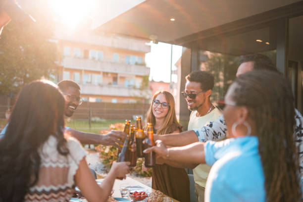 istock Multicultural Friends Drinking On A Farewell Party 1496511642