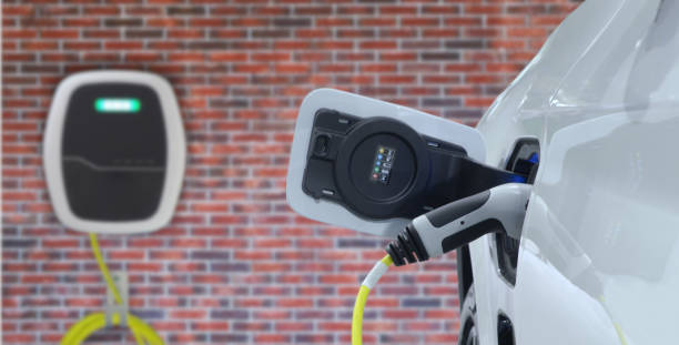 istock Close-up EV plug connected white modern EV Car for recharging battery energy from electric charge machine 1496514471