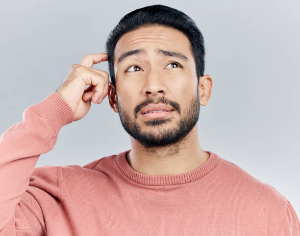 Thinking, confused and doubt with a man in studio on a gray background looking thoughtful or contemplative. Question, idea and memory with a young asian male trying to remember but feeling unsure Thinking, confused and doubt with a man in studio on a gray background looking thoughtful or contemplative. Question, idea and memory with a young asian male trying to remember but feeling unsure confusion raised eyebrows human face men stock pictures, royalty-free photos & images