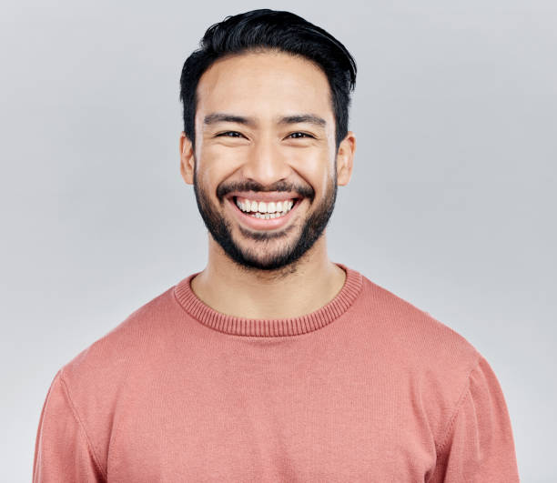 istock Face portrait, smile and happy Asian man in studio isolated on a white background or backdrop. Funny, fashion and young, confident and proud, handsome male model or person with positive mindset. 1496515112