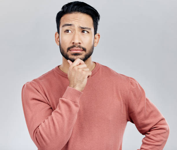 istock Confused, thinking and Asian man with ideas, decision and thoughtful against grey studio background. Japan, male and guy with wonder, opportunity and confused with thoughts, contemplation and future 1496515124