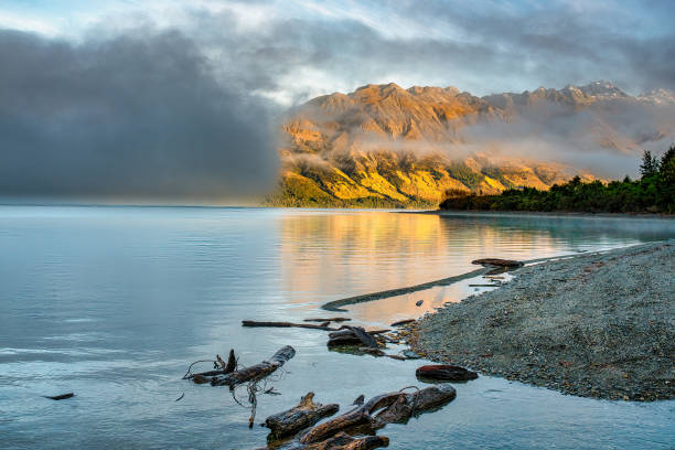 istock Cloud rolling across the lake obscuring the mountains 1496521602