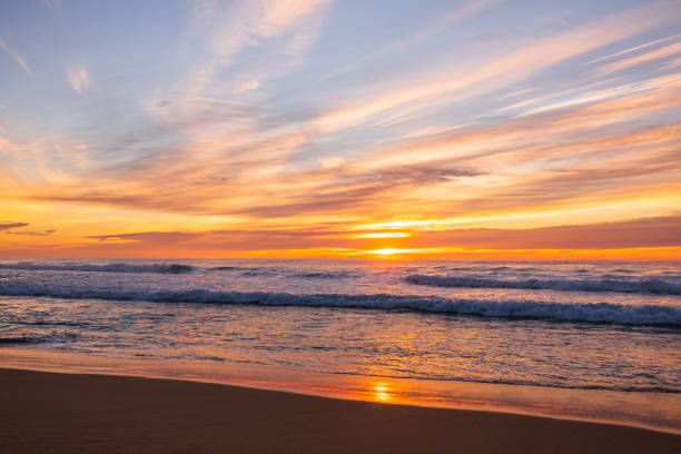 Sunrise by the ocean reflecting a beautiful golden sunrise. Mollymook, South Coast, NSW, Australia