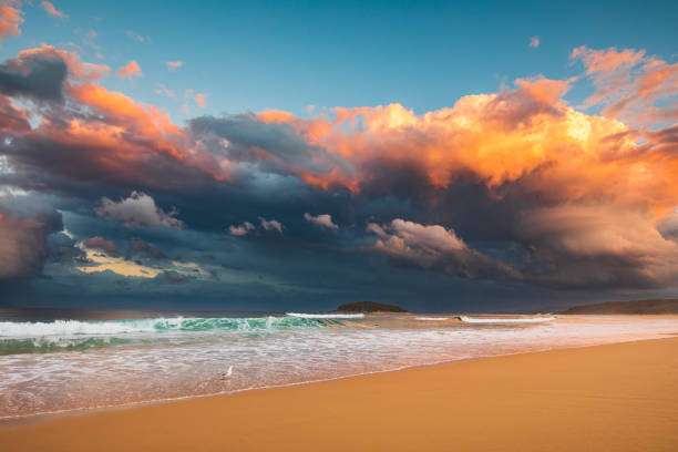 istock Coastal seascape of dramatic storm cell system over ocean illuminated by sunset 1496525036
