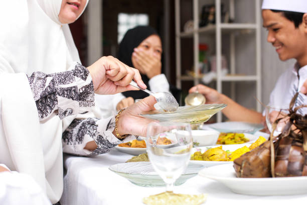 istock Woman serving food during eid moment 1496527442