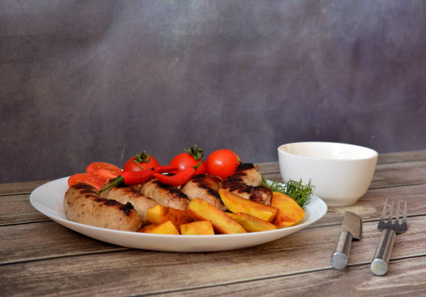 Closeup of grilled beef and vegetables, kebab  with mashed potatoes and bread.