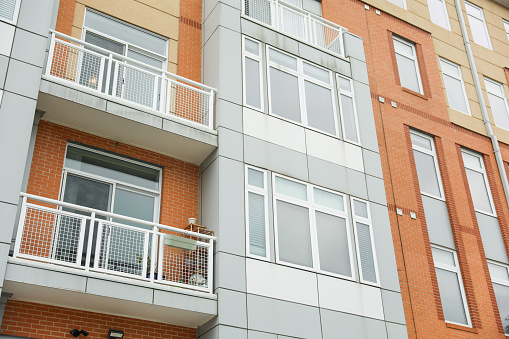 Modern buildings with large window glasses: symbols of transparency, openness, connection to the outside world, and the merging of architecture and nature.