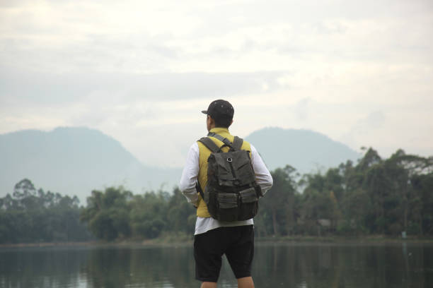 istock Rear view of backpacker enjoying mountain view 1496539416