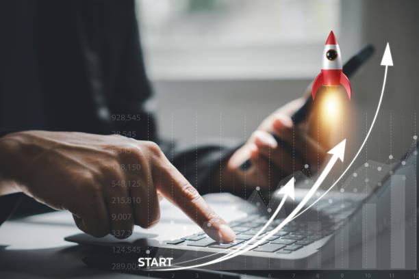 istock Business startup concept with a rocket icon launching from a laptop 1496540809
