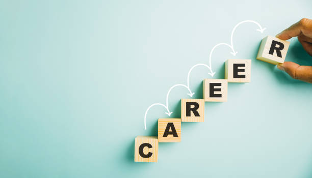 istock hand placing a wooden cube block labeled CAREER on a blue background 1496540873