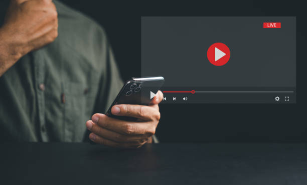 istock Man enjoying video streaming on virtual screen with a smartphone 1496540905