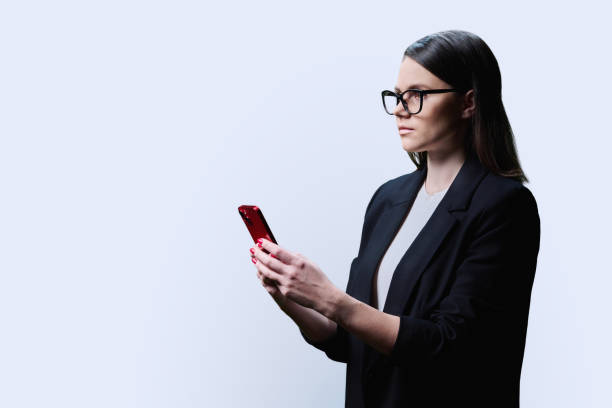 istock Young business woman with smartphone, on white background 1496541126
