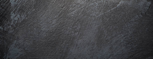 Rough grainy textured wall with black and blue paint stock photo