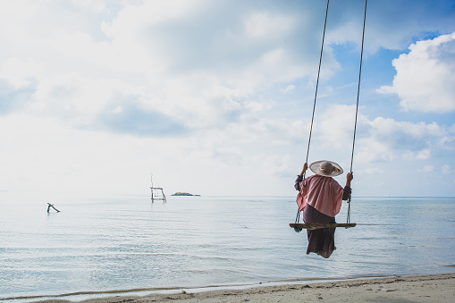 Woman swinging at the beach