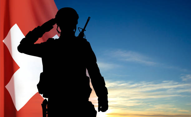 istock Silhouette of a soldier with Switzerland flag on sky 1496546778