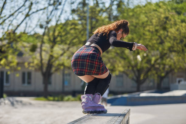 istock Young skater grinding on a ledge in a skatepark. Cool female roller blader in aggressive inline skates performing a ao pornstar trick 1496547687