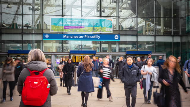 Time lapse of Crowd people and commuter pedestrians traveling and walking at Manchester Piccadilly station in downtown district of Manchester City, United Kingdom