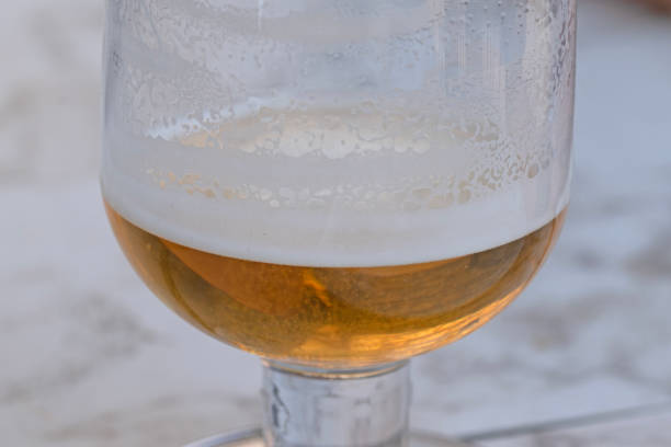 istock Close up image of half empty beer glass 1496553309