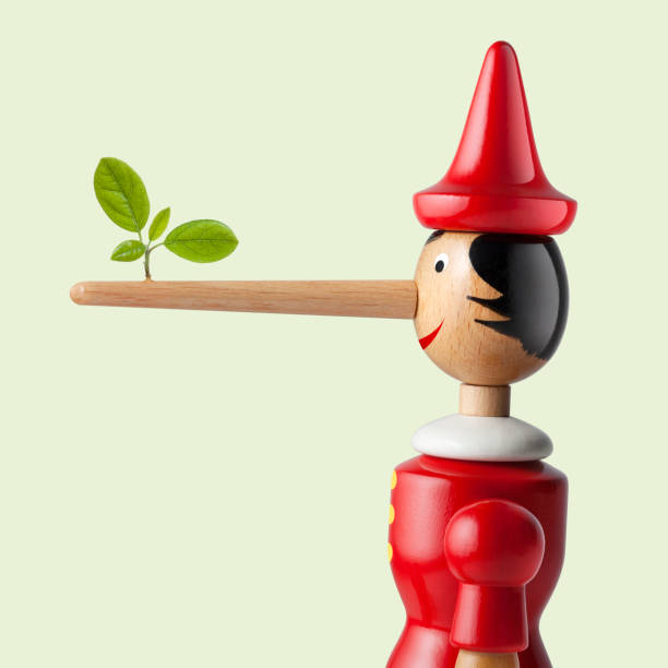 Lies about climate change. Pinocchio with leaf. stock photo