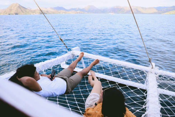 istock Couple relaxing on boat in ocean 1496554428