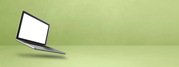 istock Floating computer laptop isolated on green. Horizontal banner background 1496554896