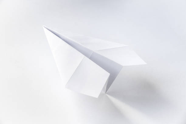 istock Paper plane origami isolated on a white background 1496555519