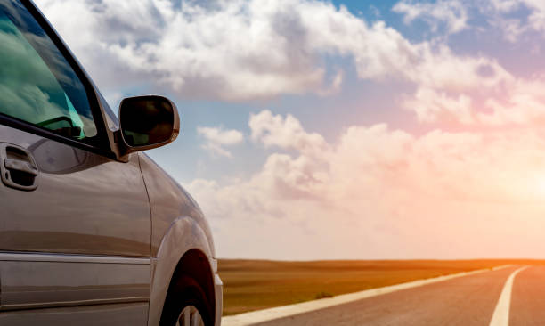 istock car parked next to the road with clear sky 1496557295