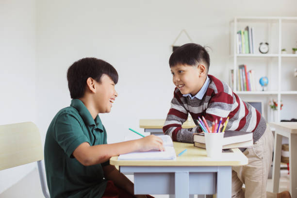 istock Smiling and cheerful schoolboys discuss  together at school 1496560819