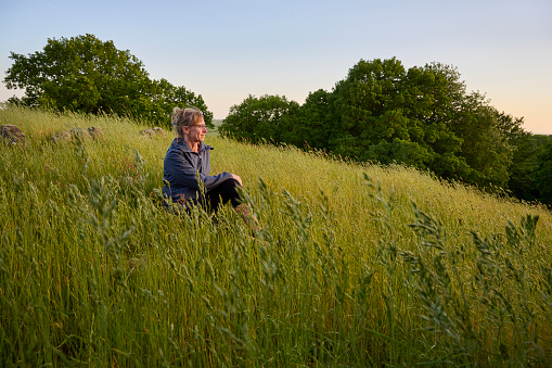 Mid adult woman trekking in Danish nature.