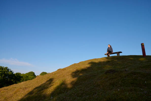 Mid adult woman trekking in Danish nature. Enjoying a viewpoint