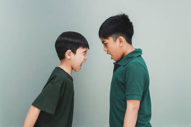 istock Two young boys screaming and fighting and clashing violently 1496562039