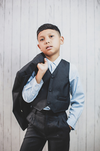 Hispanic confident boy wearing formal suit