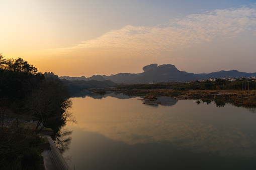 Rock formations lining the nine bend river or Jiuxi in Wuyishan or Mount wuyi scenic area in Wuyi China in fujian province during the sunset