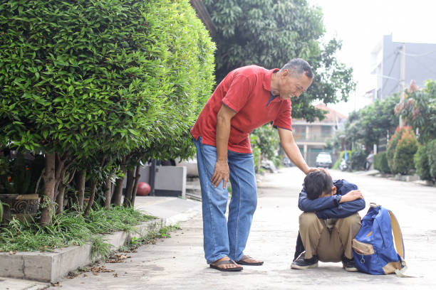 Old man homeless reach out to get bread from donor on corridor bridge